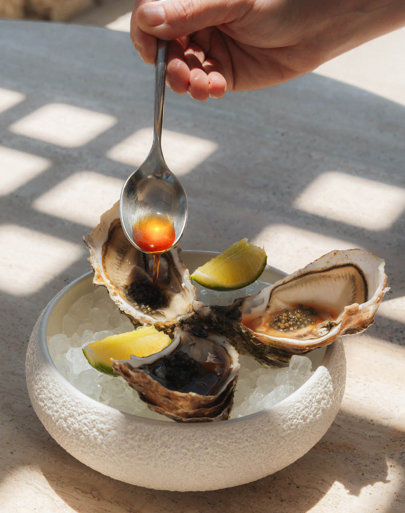 At Cali Mykonos, indulge in fresh oysters and premium caviar served on ice. This luxurious seafood platter promises a refined dining experience, highlighting the freshest flavors of the sea against a backdrop of elegance and sophistication.