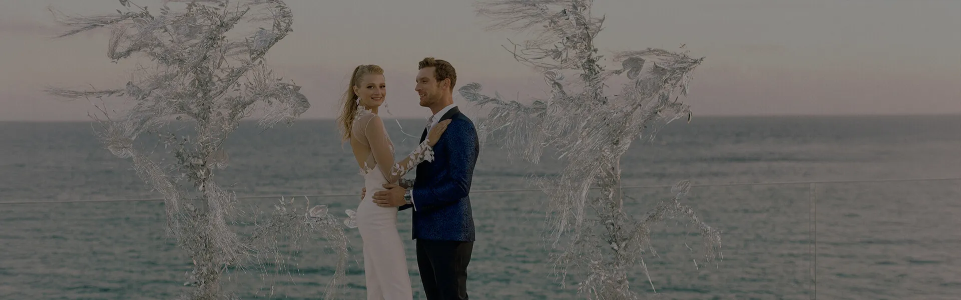 A romantic wedding ceremony at Cali Mykonos overlooking the sparkling Aegean Sea. The bride and groom exchange vows in a breathtaking coastal setting, surrounded by luxury, elegance, and Mediterranean charm. Cali Mykonos wedding venue offers stunning views, luxury accommodations, and personalized service, creating unforgettable moments for couples celebrating their special day.