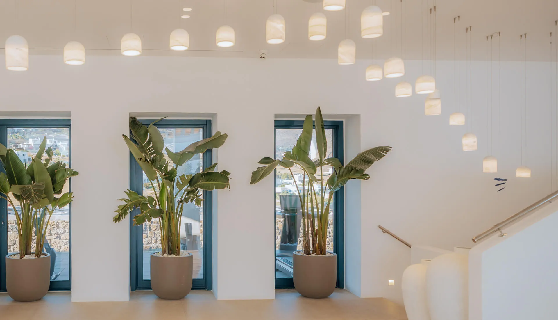 Bright and sophisticated lobby reception at Cali Mykonos, exemplifying luxury hospitality and warm, attentive service in a stunning seaside resort.